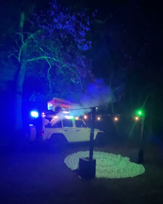 BoomBoxCar illuminated in blue and green at night