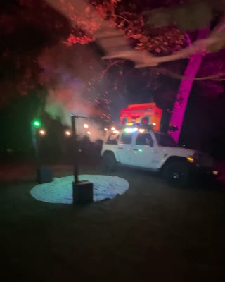 BoomBoxCar glowing under colorful nighttime lights
